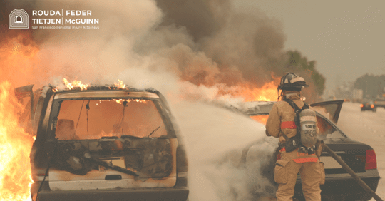 firefighter extinguishing car fire