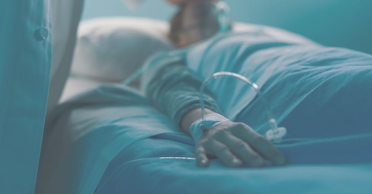 a man laying in a hospital bed