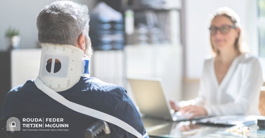 man in a neck brace talking to a doctor