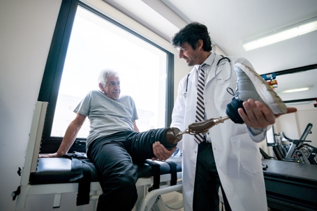 a doctor holding a patient's leg prosthesis