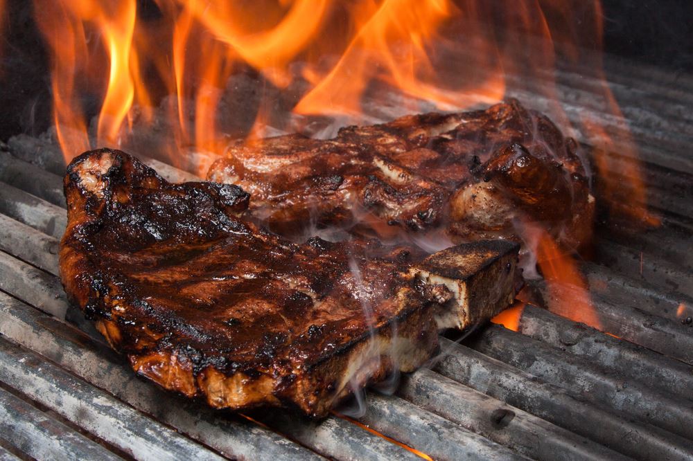 Steak cooking on gas grill